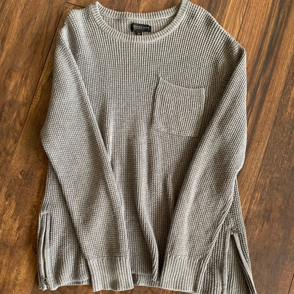 Cable knit sweater with zipper on sides.